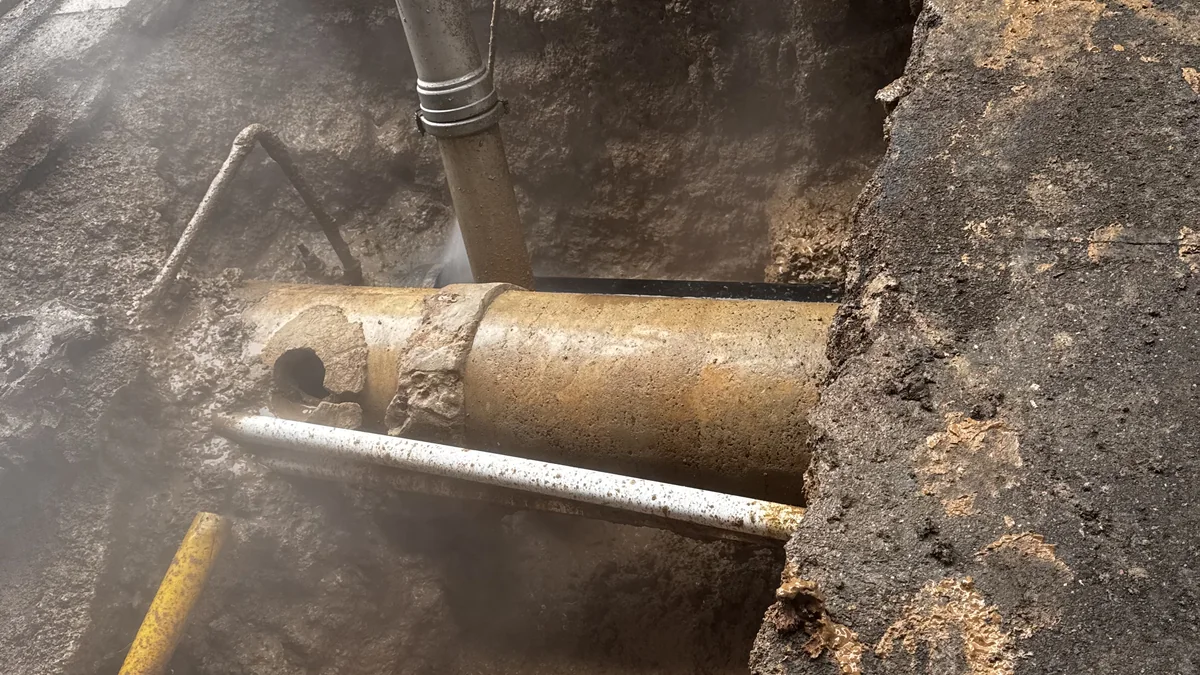 Vacuum excavation equipment exposing underground pipes in a targeted opening