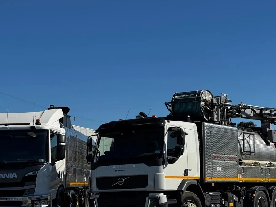 Two trucks in an industrial yard
